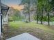 Grassy backyard featuring mature trees and ample space for outdoor activities at 8007 Northcrest Dr, Jonesboro, GA 30238