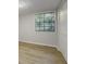 Finished basement with light hardwood flooring and a window with natural light at 8007 Northcrest Dr, Jonesboro, GA 30238