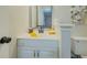 Stylish bathroom vanity with modern mirror, white cabinets, and yellow accents at 8007 Northcrest Dr, Jonesboro, GA 30238