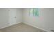 Bright bedroom featuring neutral paint, carpet, window and an interior door at 8007 Northcrest Dr, Jonesboro, GA 30238