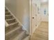 Inviting entryway featuring neutral paint, carpeted stairs, and wood-look floors at 8007 Northcrest Dr, Jonesboro, GA 30238