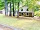 Two-story home with lawn and mature trees and partial stone facade at 8007 Northcrest Dr, Jonesboro, GA 30238