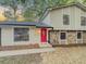Charming two-story home with a well-maintained lawn, stone accents and bright red front door at 8007 Northcrest Dr, Jonesboro, GA 30238