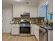 Modern kitchen with stainless steel appliances, stone countertops, mosaic backsplash and new flooring at 8007 Northcrest Dr, Jonesboro, GA 30238