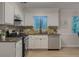 Modern kitchen with stainless steel appliances, stone countertops, mosaic backsplash and new flooring at 8007 Northcrest Dr, Jonesboro, GA 30238