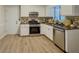 Modern kitchen with stainless steel appliances, stone countertops, mosaic backsplash and new flooring at 8007 Northcrest Dr, Jonesboro, GA 30238