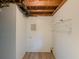 A functional laundry room with exposed ceiling, washer hookups, and shelving at 8007 Northcrest Dr, Jonesboro, GA 30238