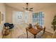 Bright living room with large windows, neutral walls, ceiling fan and modern flooring at 8007 Northcrest Dr, Jonesboro, GA 30238