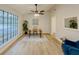 Bright living room with large windows, neutral walls, ceiling fan and modern flooring at 8007 Northcrest Dr, Jonesboro, GA 30238