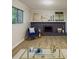 Cozy living room with stone fireplace, new floors, and a comfortable blue armchair at 8007 Northcrest Dr, Jonesboro, GA 30238