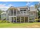 Exterior view of the home featuring a screened porch, balcony, patio, and a large backyard at 1064 Highway 20 E, Mcdonough, GA 30252