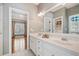 Bathroom with double sinks, white cabinetry, and large mirror, blending functionality with style at 1064 Highway 20 E, Mcdonough, GA 30252