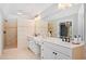 Bathroom with double sinks, tile shower, and tile flooring at 1064 Highway 20 E, Mcdonough, GA 30252