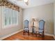 Charming bedroom with two chairs, hardwood floors, custom window treatments, and plantation shutters at 1064 Highway 20 E, Mcdonough, GA 30252