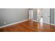 Bedroom featuring neutral paint and hardwood flooring, leading to an open ensuite bathroom at 1064 Highway 20 E, Mcdonough, GA 30252