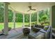 Relaxing covered patio with a ceiling fan, outdoor furniture and a fire pit overlooking the backyard and green landscaping at 1064 Highway 20 E, Mcdonough, GA 30252