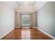 Elegant dining room with tray ceiling, hardwood floors, and decorative window treatments at 1064 Highway 20 E, Mcdonough, GA 30252