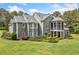 Rear exterior view of the house with a screened-in porch and large backyard at 1064 Highway 20 E, Mcdonough, GA 30252