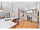 Bright kitchen features white cabinets, stainless steel appliances, and hardwood floors at 1064 Highway 20 E, Mcdonough, GA 30252