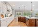 Open kitchen with white countertops, island, stainless steel appliances, and wood floors at 1064 Highway 20 E, Mcdonough, GA 30252