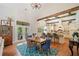 Open dining room and kitchen area with wood beams, white cabinets, and barstool seating at 1064 Highway 20 E, Mcdonough, GA 30252