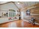 Unique living room with wood paneling, vaulted ceiling, and a cozy window seat with storage at 1064 Highway 20 E, Mcdonough, GA 30252