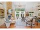 Sun-drenched living room with stone fireplace, hardwood floors, and stylish decor at 1064 Highway 20 E, Mcdonough, GA 30252