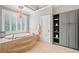 Main bathroom with soaking tub, tile floors, and built-in storage at 1064 Highway 20 E, Mcdonough, GA 30252