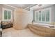 Main bathroom with soaking tub, walk in shower with and tile floors at 1064 Highway 20 E, Mcdonough, GA 30252