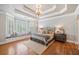 Large main bedroom with hardwood floors, tray ceiling, large windows and window seat at 1064 Highway 20 E, Mcdonough, GA 30252