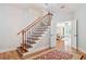 Elegant staircase with wood and iron accents, leading to a bright, open living space at 1064 Highway 20 E, Mcdonough, GA 30252