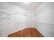 Spacious walk-in closet featuring white walls, hardwood floors, and adjustable shelving for maximum storage at 1064 Highway 20 E, Mcdonough, GA 30252
