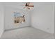 Bedroom featuring a ceiling fan, carpet flooring, and large window at 1481 Wild Rye Ln, Grayson, GA 30017