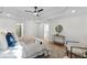 Bright primary bedroom featuring ceiling fan, tray ceiling, wood floors, and neutral decor at 1481 Wild Rye Ln, Grayson, GA 30017
