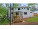 Two-story white brick home with an outdoor wooden deck and stairs leading down to the backyard at 3267 Sewell Mill Rd, Marietta, GA 30062