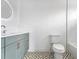 Stylish bathroom featuring a modern vanity, decorative tile floor, and an elegant round mirror at 3267 Sewell Mill Rd, Marietta, GA 30062