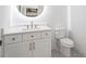 Stylish bathroom featuring a modern vanity with a round mirror and decorative floor tiles at 3267 Sewell Mill Rd, Marietta, GA 30062