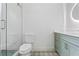 Elegant bathroom with a light blue vanity, decorative floor tiles, and glass shower door at 3267 Sewell Mill Rd, Marietta, GA 30062