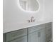 Bathroom vanity with a white countertop, gray cabinets and a large, lighted mirror at 3267 Sewell Mill Rd, Marietta, GA 30062
