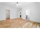 Bright bedroom with hardwood floors and two open doors leading to an en suite bathroom and closet at 3267 Sewell Mill Rd, Marietta, GA 30062