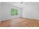 Bright bedroom with hardwood floors, a ceiling fan, and a large window with natural light at 3267 Sewell Mill Rd, Marietta, GA 30062