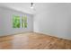 Bright bedroom with hardwood floors, a ceiling fan, and a large window with natural light at 3267 Sewell Mill Rd, Marietta, GA 30062