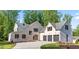 Stunning stone and brick home with a three-car garage and modern design elements at 3267 Sewell Mill Rd, Marietta, GA 30062