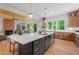 Open kitchen and living area with hardwood floors, stylish island seating, and modern fixtures at 3267 Sewell Mill Rd, Marietta, GA 30062