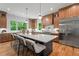 Gourmet kitchen featuring a large center island with seating, stainless steel appliances, and a view of the backyard at 3267 Sewell Mill Rd, Marietta, GA 30062