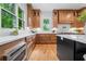 Modern kitchen with stainless steel appliances, white countertops, and light wood cabinets at 3267 Sewell Mill Rd, Marietta, GA 30062