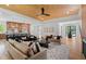 Open-concept living room with hardwood floors, modern furniture, and a view into the kitchen area at 3267 Sewell Mill Rd, Marietta, GA 30062