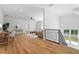 Open-concept living room with hardwood floors, modern decor, and staircase with black railing at 3267 Sewell Mill Rd, Marietta, GA 30062