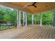 Relaxing covered porch with wood flooring, white columns, and a scenic view of the surrounding greenery at 3267 Sewell Mill Rd, Marietta, GA 30062