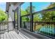 Balcony view showcases the exterior siding, black framed windows, and nearby greenery at 34 Candler Ne Rd, Atlanta, GA 30317